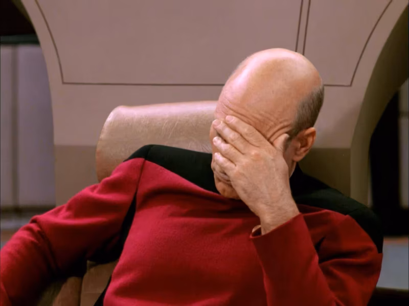 Captain Jean-Luc Picard from Star Trek performing a facepalm, expressing frustration